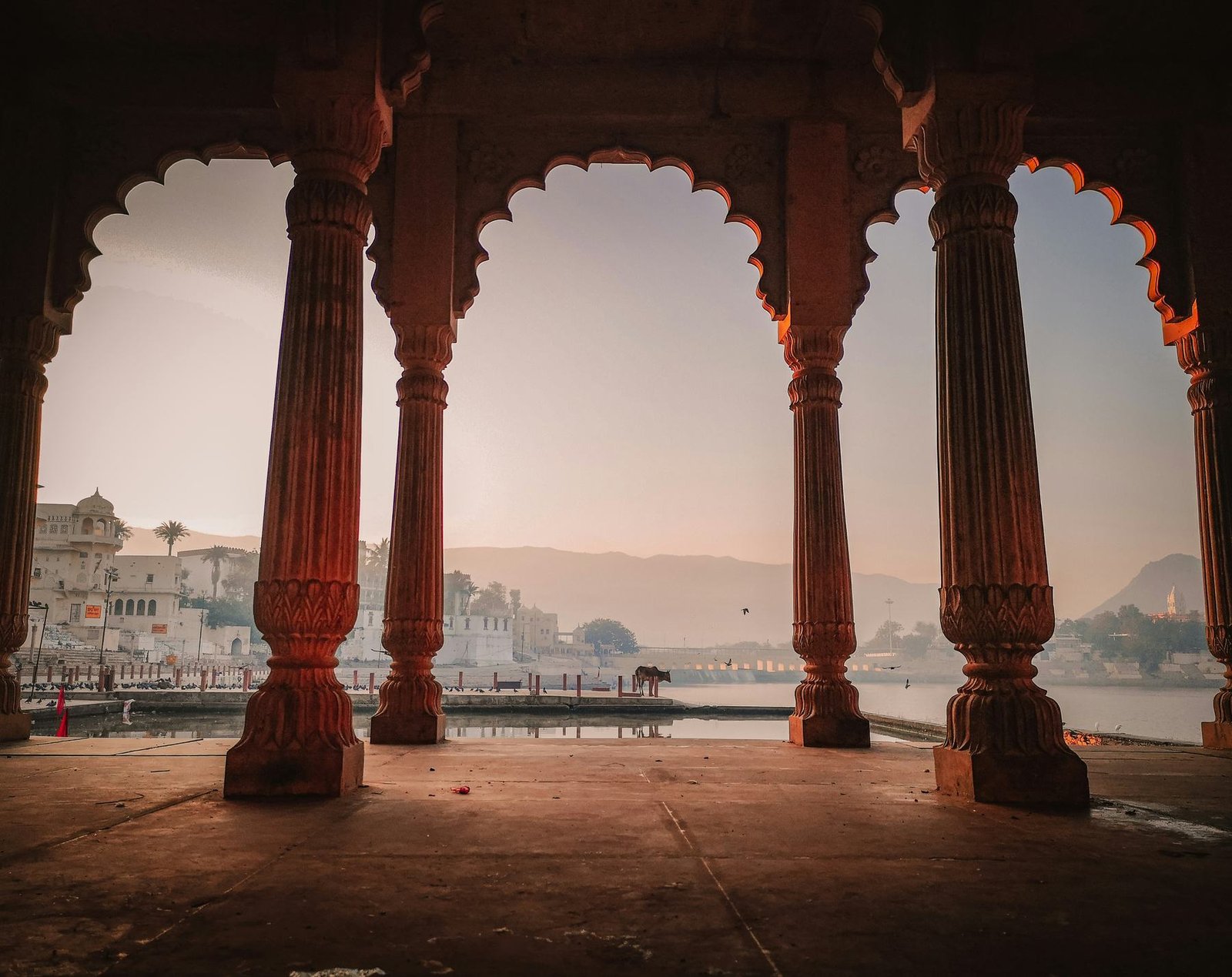 View of Pushkar through carved sandstone arches